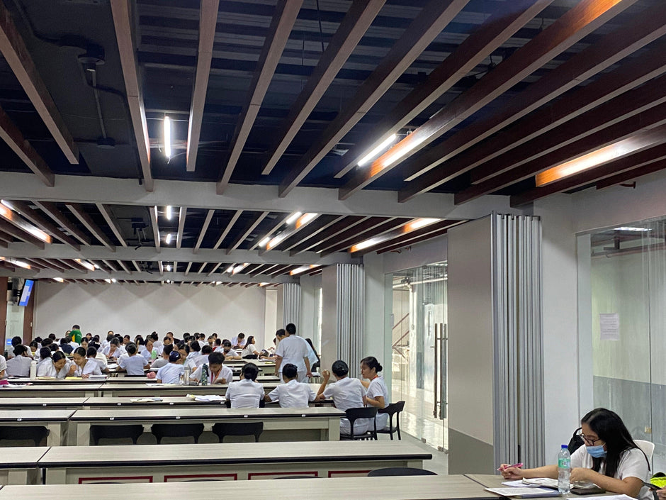 A classroom full of students and a folding wall divider in melamine finish installed in a school in Manila Philippines