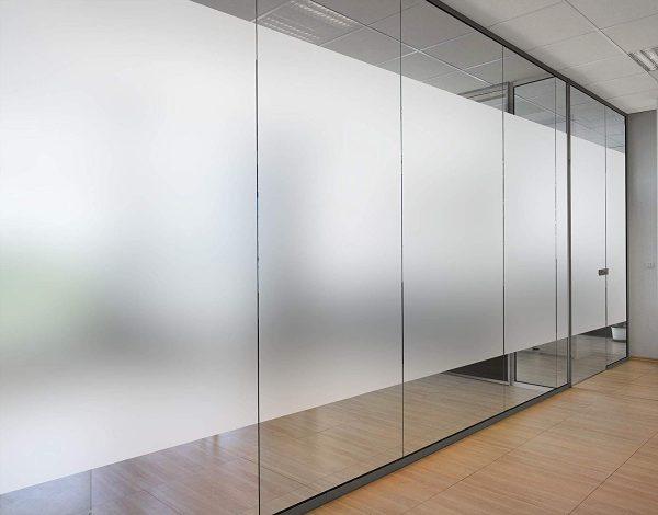 A modern office space with a glass partition wall.