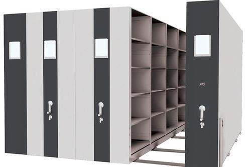 File compactor system with a track-based design, featuring open shelving units for efficient document storage. The compactors have lockable handles and are designed for high-density storage in a compact, space-saving layout.