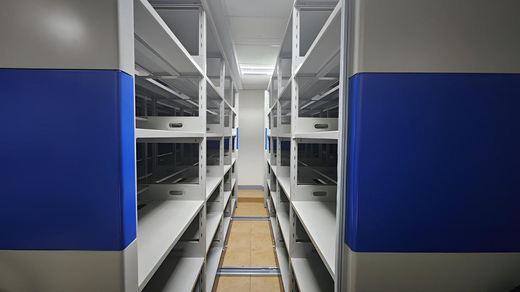 The image shows a file compactor system with multiple rows of empty metal shelves.