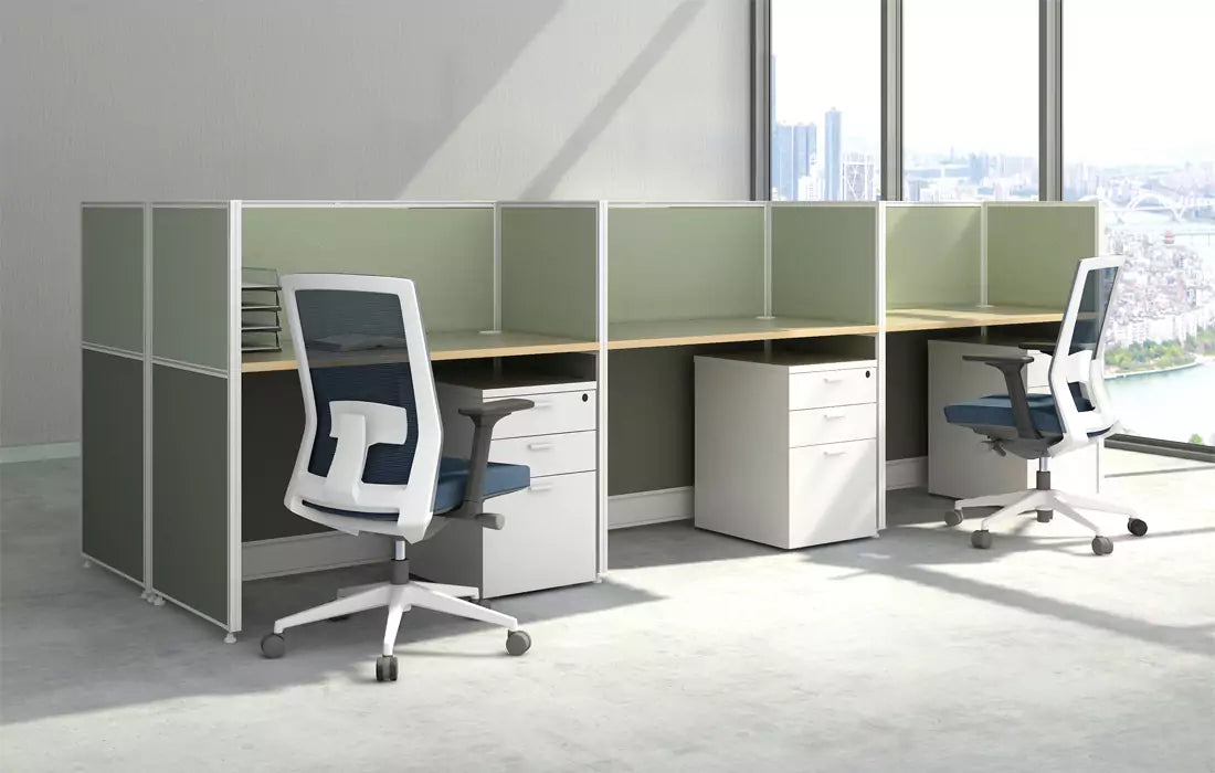 A contemporary, open-plan office cubicle featuring two individual workstations separated by a low, light-colored partition.